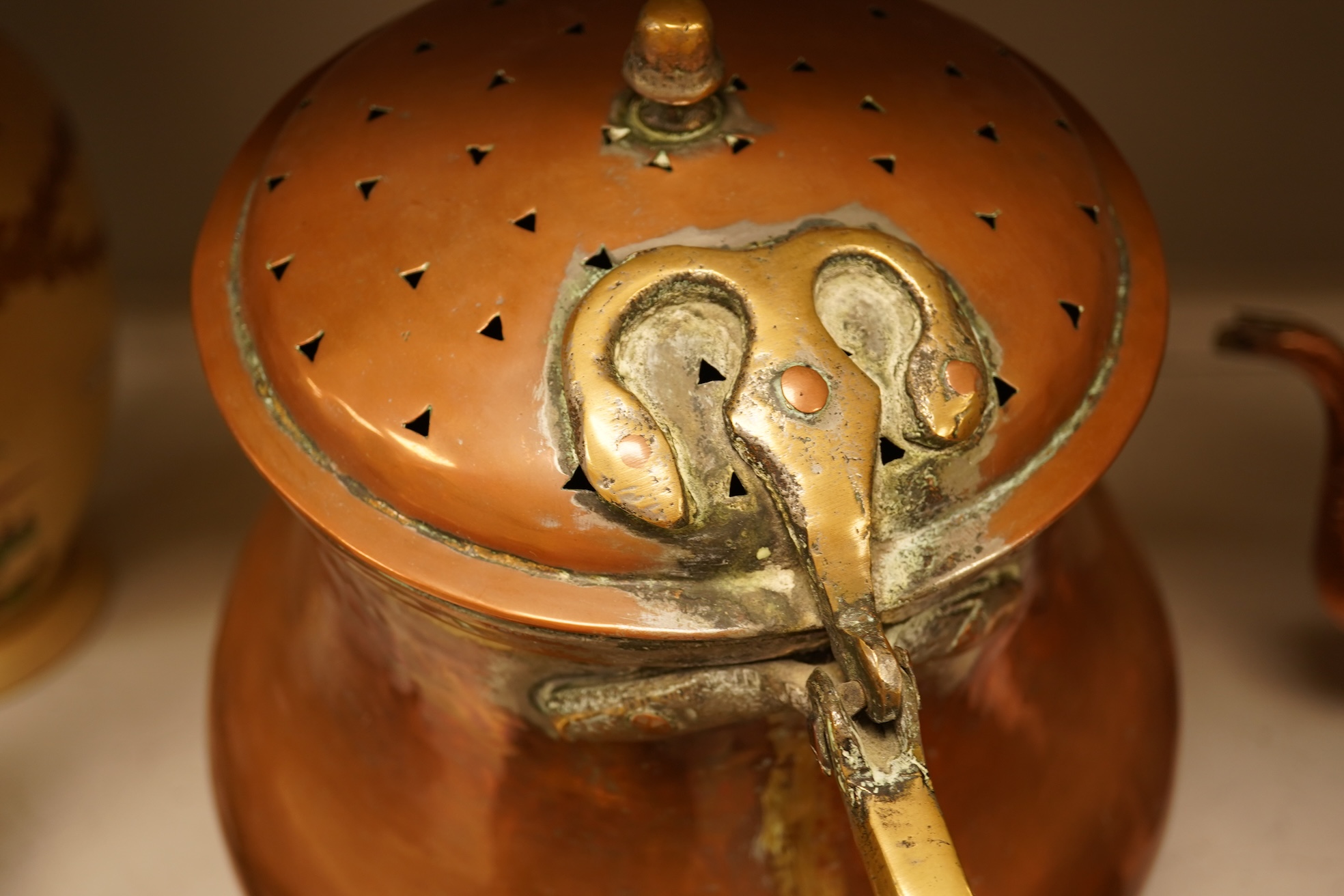 Four various copper vessels and a brass teapot, tallest 47cm